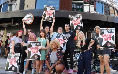 Members of Twin Cities United Performers stand in front of the First Avenue nightclub with signs supporting contracts for performers with First Avenue.