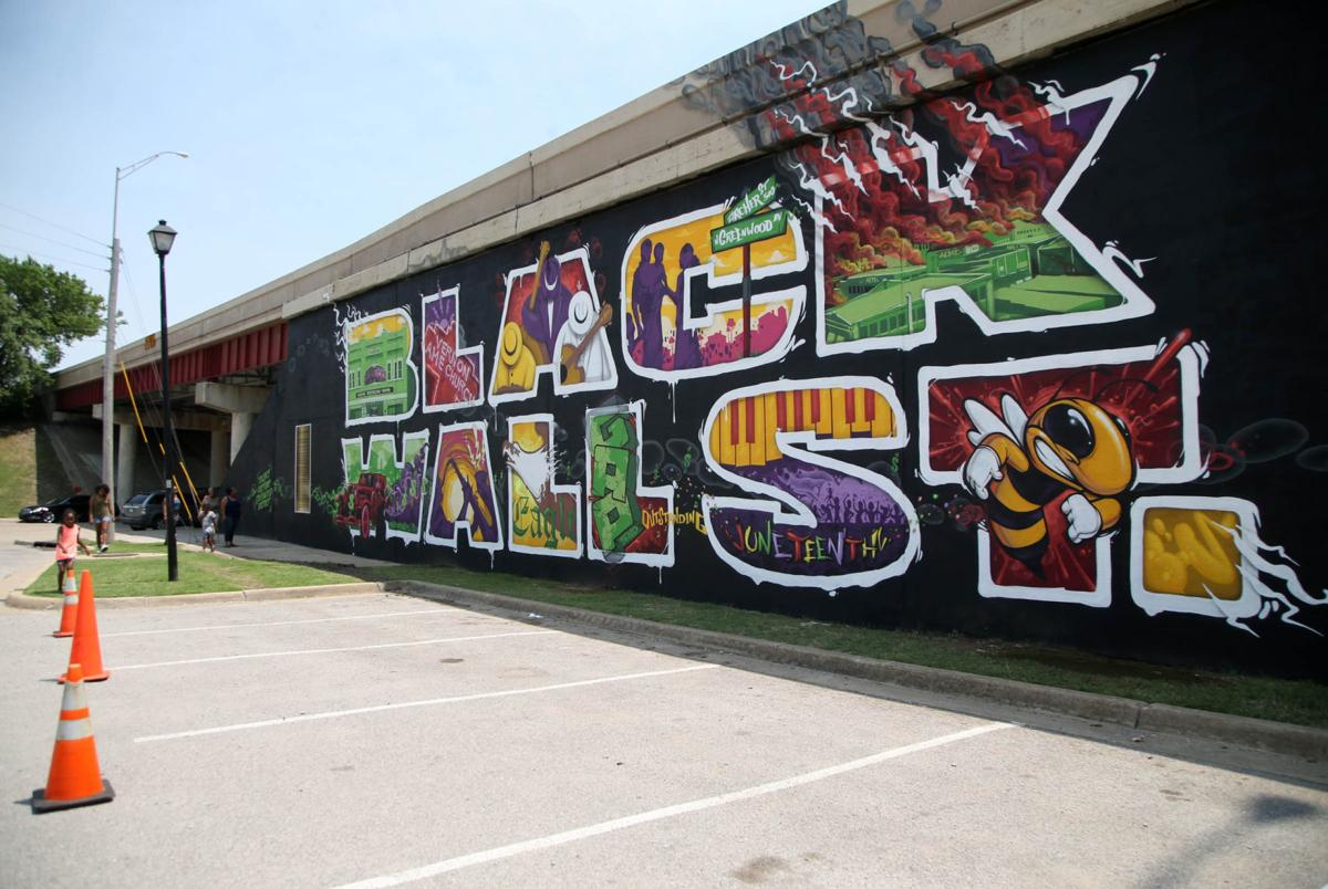 Image shows a panorama of the mural commemorating Black Wall Street in Greenwood, Oklahoma, taken shortly after its completion in 2018.