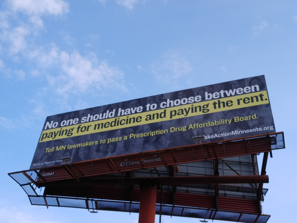 Billboard that says "No one should have to choose between paying for medicine and paying the rent. Tell MN lawmakers to pass a Prescription Drug Affordability Board."