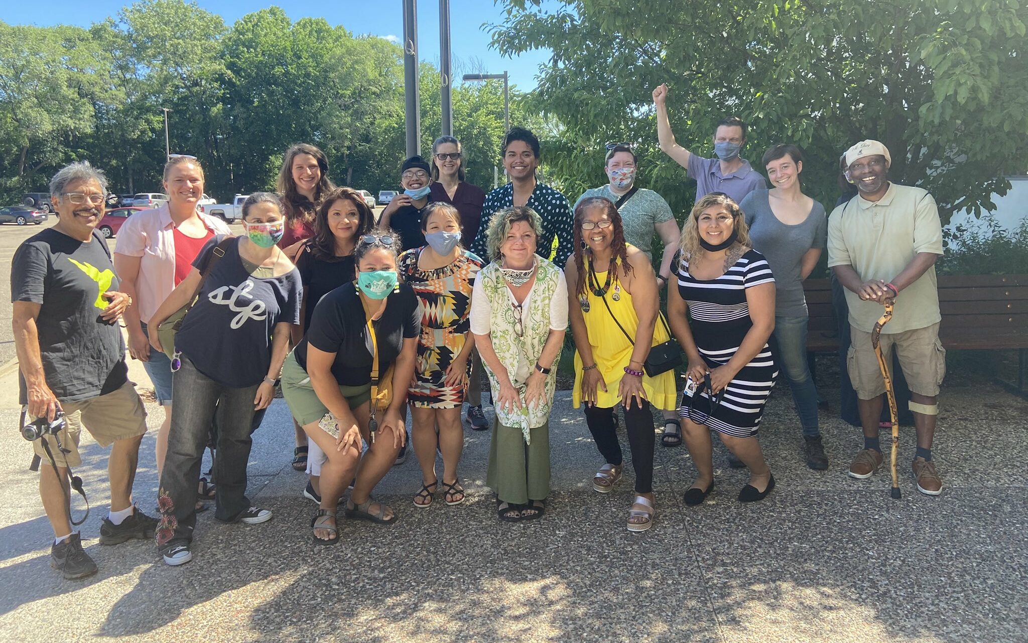 Members and volunteers with the Housing Equity Now St. Paul (HENS) Coalition pose for a victory photo.